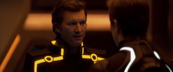 Movie still from “TRON: Legacy” (2010), directed by Joseph Kosinski – A man in a suit is reflected in a mirror; Close Up shot, Over the shoulder angle
