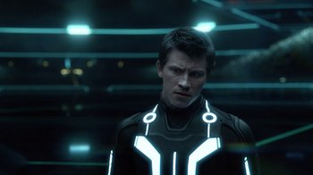 Movie still from “TRON: Legacy” (2010), directed by Joseph Kosinski – A man in a tron costume looking at the camera; Close Up shot, Over the shoulder angle