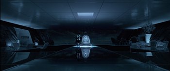 Movie still from “TRON: Legacy” (2010), directed by Joseph Kosinski – A man sitting on the ground in front of a mirror; Wide shot, High angle