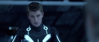 Movie still from “TRON: Legacy” (2010), directed by Joseph Kosinski – A young man in a tron suit looking into the distance; Close Up shot, Low angle