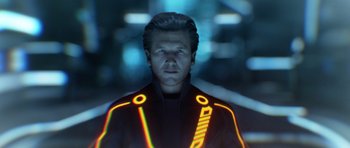 Movie still from “TRON: Legacy” (2010), directed by Joseph Kosinski – A man in a jacket with neon lights around it; Close Up shot, Over the shoulder angle