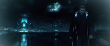 Movie still from “TRON: Legacy” (2010), directed by Joseph Kosinski – A man standing in front of a city at night; Medium shot, Over the shoulder angle