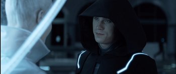 Movie still from “TRON: Legacy” (2010), directed by Joseph Kosinski – A man wearing a black jacket and a hood; Close Up shot, Over the shoulder angle