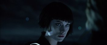 Movie still from “TRON: Legacy” (2010), directed by Joseph Kosinski – A person with short black hair; Close Up shot, Low angle