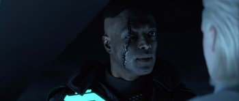 Movie still from “TRON: Legacy” (2010), directed by Joseph Kosinski – A person with a scar on his face; Close Up shot, Over the shoulder angle