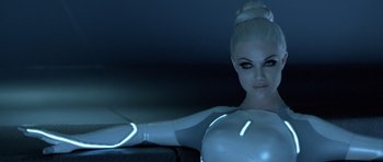 Movie still from “TRON: Legacy” (2010), directed by Joseph Kosinski – A woman in a futuristic costume poses for the camera; Close Up shot, Low angle