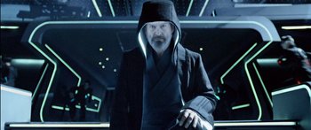 Movie still from “TRON: Legacy” (2010), directed by Joseph Kosinski – A man wearing a black robe and a hood; Medium shot, Low angle