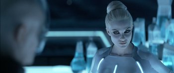 Movie still from “TRON: Legacy” (2010), directed by Joseph Kosinski – A woman with blonde hair and blue eyes in a futuristic setting; Close Up shot, Over the shoulder angle