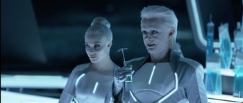 Movie still from “TRON: Legacy” (2010), directed by Joseph Kosinski – A man and a woman dressed in futuristic clothing; Medium shot, Over the shoulder angle