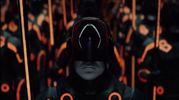 Movie still from “TRON: Legacy” (2010), directed by Joseph Kosinski – A man with a helmet on his head in front of a bunch of people; Close Up shot, High angle