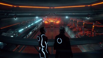 Movie still from “TRON: Legacy” (2010), directed by Joseph Kosinski – Two people in black and white suits looking out over a building; Wide shot, Low angle