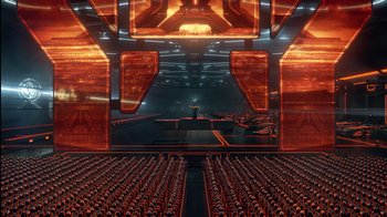 Movie still from “TRON: Legacy” (2010), directed by Joseph Kosinski – An image of an auditorium with a large screen; Extreme Wide shot, High angle