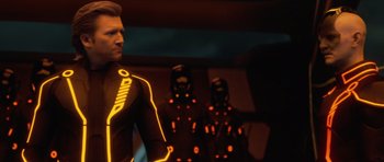 Movie still from “TRON: Legacy” (2010), directed by Joseph Kosinski – A group of people that are standing in a room; Medium shot, Over the shoulder angle
