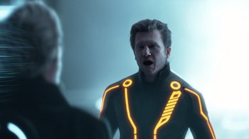 Movie still from “TRON: Legacy” (2010), directed by Joseph Kosinski – A man in a black jacket is looking at another man; Close Up shot, Over the shoulder angle