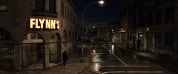 Movie still from “TRON: Legacy” (2010), directed by Joseph Kosinski – A person walking down a street at night; Extreme Wide shot, High angle