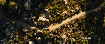 Movie still from “Taken 2” (2012), directed by Olivier Megaton – An aerial view of a truck driving down a road; Extreme Wide shot, Overhead angle