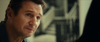 Movie still from “Taken 2” (2012), directed by Olivier Megaton – A man's face in front of stairs; Close Up shot, Over the shoulder angle