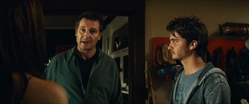 Movie still from “Taken 2” (2012), directed by Olivier Megaton – A man standing next to another man in front of a mirror; Medium shot, Over the shoulder angle