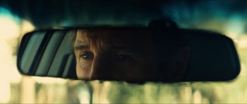 Movie still from “Taken 2” (2012), directed by Olivier Megaton – A man's face through a car window; Extreme Close Up shot, Over the shoulder angle