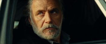 Movie still from “Taken 2” (2012), directed by Olivier Megaton – An old man with a beard looking at the camera; Close Up shot, Low angle