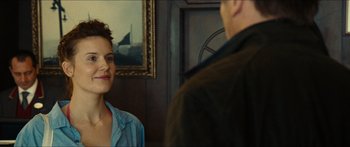 Movie still from “Taken 2” (2012), directed by Olivier Megaton – A man and a woman standing next to each other in a room; Close Up shot, Over the shoulder angle