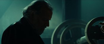 Movie still from “Taken 2” (2012), directed by Olivier Megaton – A person in a dark room; Close Up shot, Over the shoulder angle