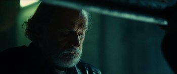 Movie still from “Taken 2” (2012), directed by Olivier Megaton – An old man with a beard looking at the camera; Close Up shot, Over the shoulder angle