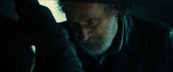 Movie still from “Taken 2” (2012), directed by Olivier Megaton – An older man with a beard and mustache; Close Up shot, Over the shoulder angle