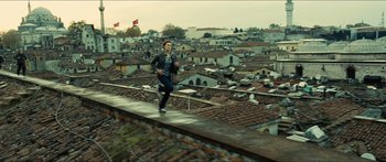 Movie still from “Taken 2” (2012), directed by Olivier Megaton – A man is running on the roof of a building; Wide shot, High angle