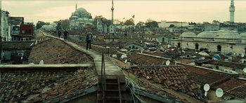 Movie still from “Taken 2” (2012), directed by Olivier Megaton – A man walking down the stairs on a roof top; Extreme Wide shot, High angle
