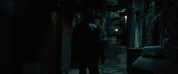 Movie still from “Taken 2” (2012), directed by Olivier Megaton – A man walking down a street at night; Wide shot, High angle