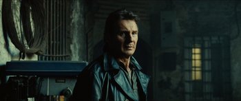 Movie still from “Taken 2” (2012), directed by Olivier Megaton – A man wearing a leather jacket looking into the distance; Close Up shot, Low angle