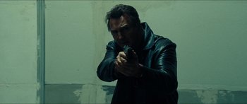 Movie still from “Taken 2” (2012), directed by Olivier Megaton – A man holding a gun in his hand; Close Up shot, Low angle