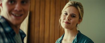 Movie still from “Taken 3” (2014), directed by Olivier Megaton – A beautiful blonde woman with a blue shirt; Close Up shot, Over the shoulder angle