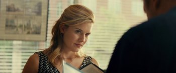 Movie still from “Taken 3” (2014), directed by Olivier Megaton – A beautiful blonde woman holding a book in her hands; Close Up shot, Over the shoulder angle