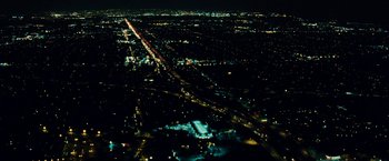 Movie still from “Taken 3” (2014), directed by Olivier Megaton – An aerial view of a city lit up at night; Extreme Wide shot, High angle