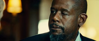 Movie still from “Taken 3” (2014), directed by Olivier Megaton – A person with a beard looking to his left; Close Up shot, Low angle