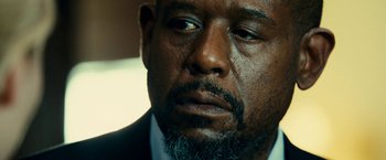 Movie still from “Taken 3” (2014), directed by Olivier Megaton – A person wearing a suit and beard; Close Up shot, Over the shoulder angle