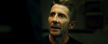 Movie still from “Taken 3” (2014), directed by Olivier Megaton – A person with a black shirt on; Close Up shot, Over the shoulder angle