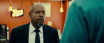 Movie still from “Taken 3” (2014), directed by Olivier Megaton – An older man in a suit and tie looking at a woman; Close Up shot, Over the shoulder angle