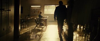Movie still from “Taken 3” (2014), directed by Olivier Megaton – A man walking down the hallway of a classroom; Wide shot, Low angle