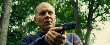 Movie still from “Taken 3” (2014), directed by Olivier Megaton – An older man holding a gun in his hand; Close Up shot, Low angle