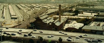 Movie still from “Taken 3” (2014), directed by Olivier Megaton – An aerial view of an industrial area with a train station; Extreme Wide shot, High angle