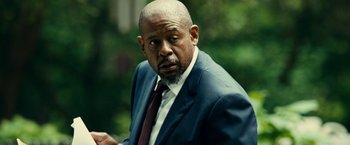 Movie still from “Taken 3” (2014), directed by Olivier Megaton – An older man in a suit and a tie; Close Up shot, Over the shoulder angle