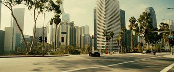 Movie still from “Taken 3” (2014), directed by Olivier Megaton – A car is driving down a street in a city; Extreme Wide shot, High angle