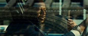 Movie still from “Taken 3” (2014), directed by Olivier Megaton – A man sitting in a car looking out the window; Close Up shot, Low angle