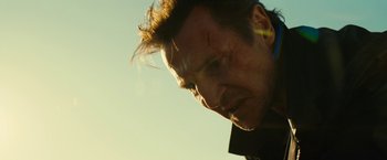 Movie still from “Taken 3” (2014), directed by Olivier Megaton – A man's face in the sunlight; Close Up shot, Low angle