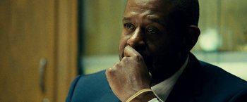 Movie still from “Taken 3” (2014), directed by Olivier Megaton – A man that is sitting in a room; Close Up shot, Over the shoulder angle