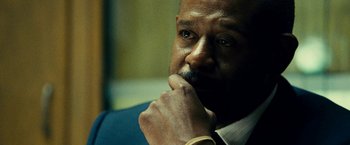 Movie still from “Taken 3” (2014), directed by Olivier Megaton – A person with a hand on his chin; Close Up shot, Over the shoulder angle