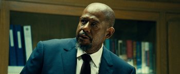 Movie still from “Taken 3” (2014), directed by Olivier Megaton – An older man in a suit and tie looking to his left; Close Up shot, Over the shoulder angle